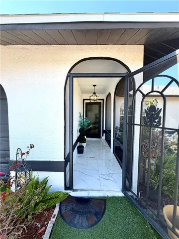 Entrance to property featuring stucco siding