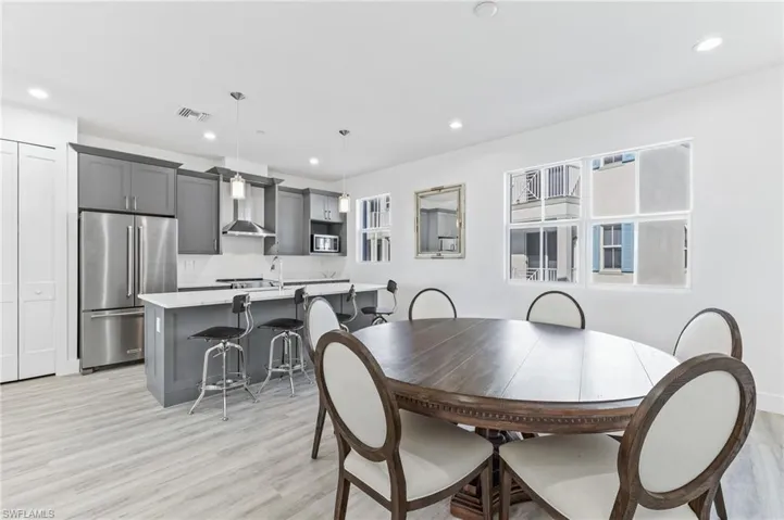 Dining space with recessed lighting and light wood finished floors