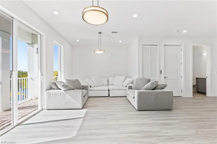 Living area with recessed lighting and light wood finished floors