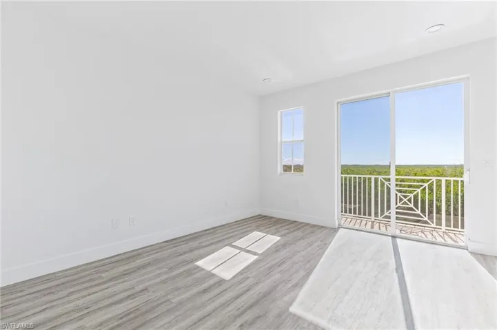 Unfurnished room featuring light wood-type flooring and baseboards