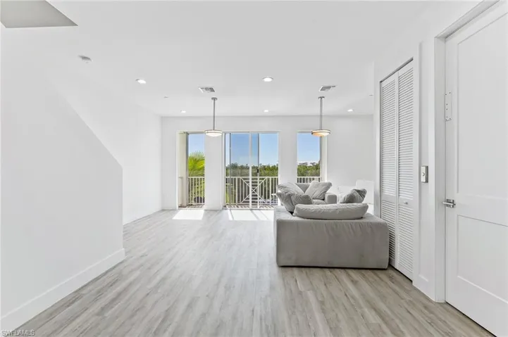 Living area featuring light wood-style floors and recessed lighting