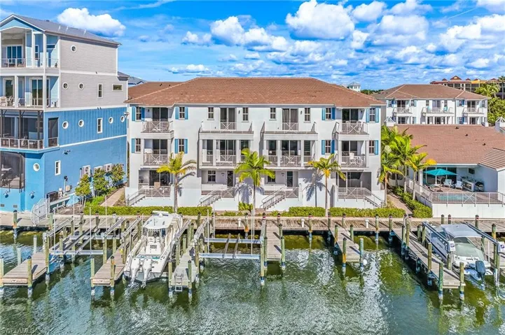 Rear view of property featuring boat lift and a water view