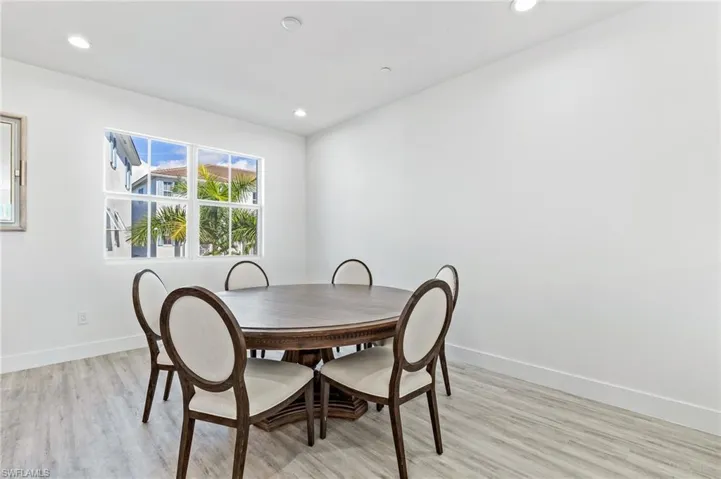 Dining space featuring light wood finished floors and recessed lighting