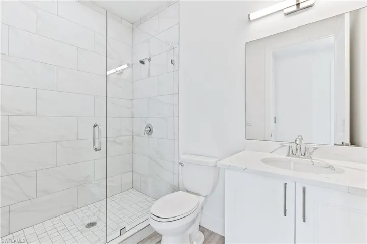Bathroom featuring vanity and a stall shower