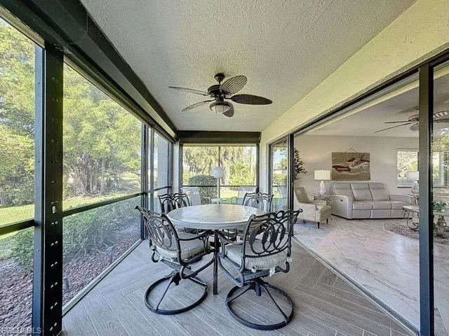 Sunroom / solarium with a ceiling fan and outdoor dining space