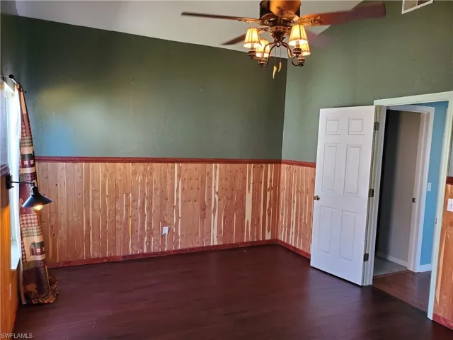 Primary bedroom with vaulted ceiling