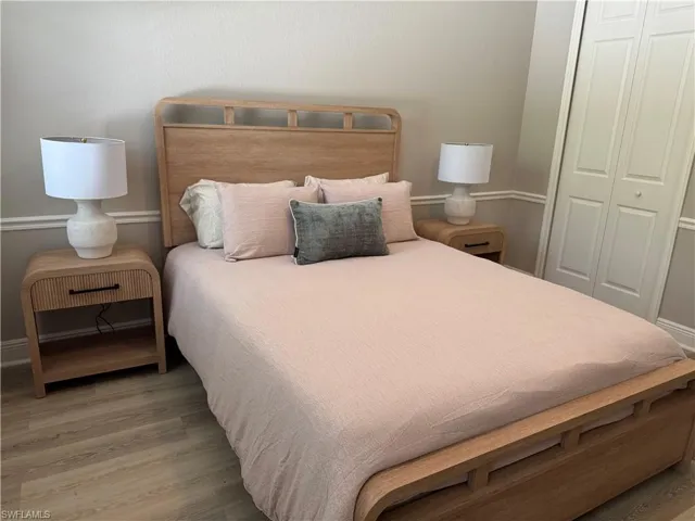 Bedroom featuring a closet, wood finished floors, and baseboards