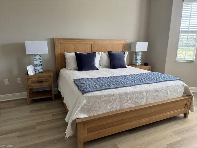 Bedroom featuring light wood-style flooring and baseboards