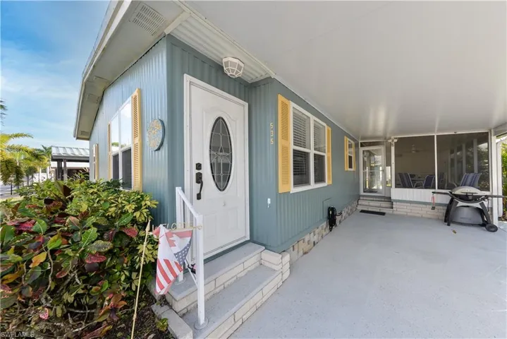 View of exterior entry with a sunroom