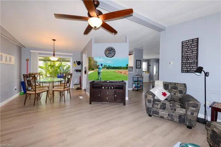 Living room featuring ceiling fan and light wood-style flooring