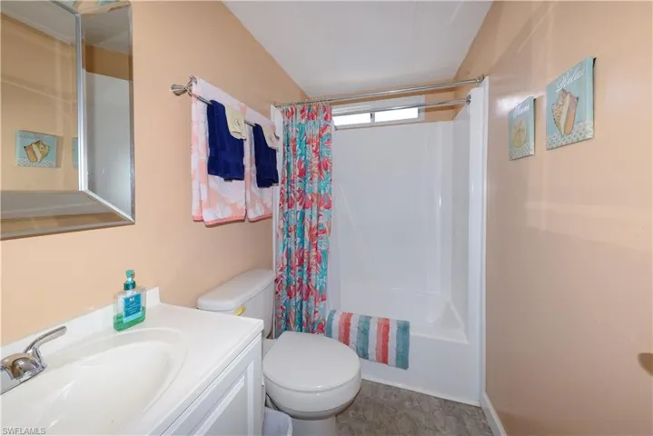 Full bath with shower / bathtub combination with curtain and vanity