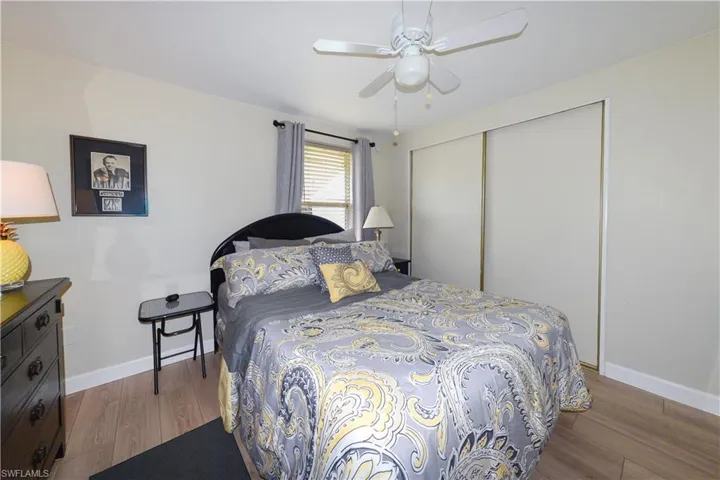 Bedroom featuring wood finished floors, a closet, and a ceiling fan