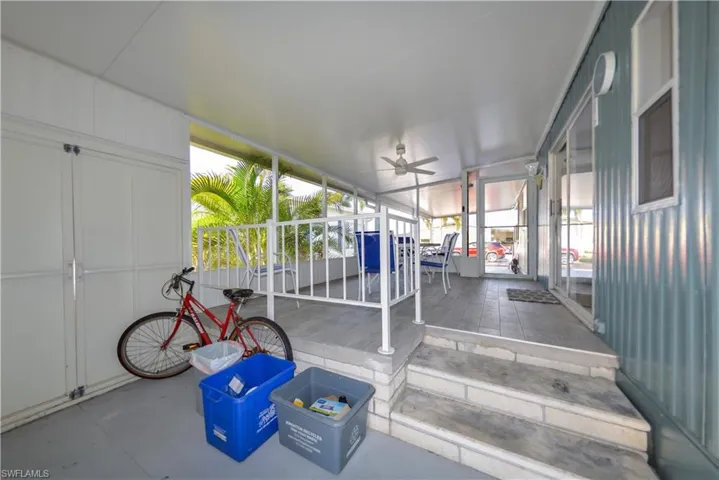Unfurnished sunroom featuring ceiling fan and outdoor dining space