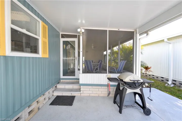 View of patio / terrace featuring a grill, outdoor dining space, and a sunroom