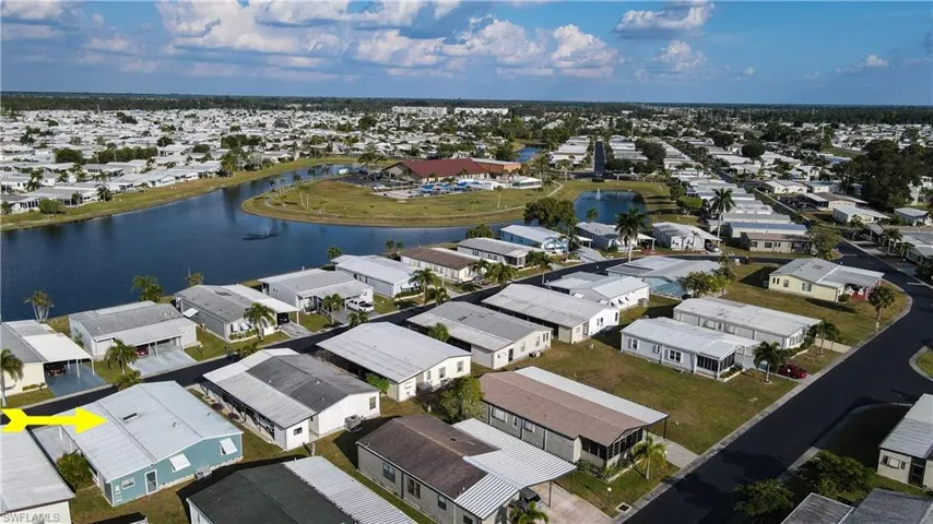 Aerial perspective of suburban area featuring a nearby body of water
