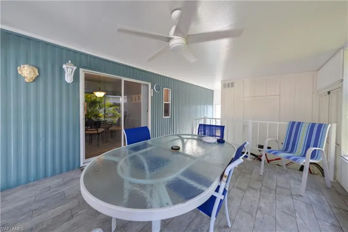 View of patio / terrace with outdoor dining area, a ceiling fan, and a sunroom