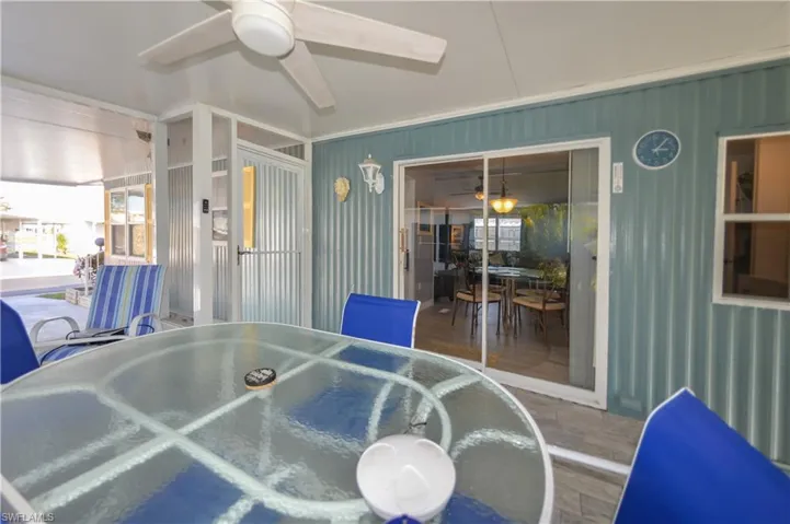 Sunroom with outdoor dining area, a ceiling fan, and plenty of natural light