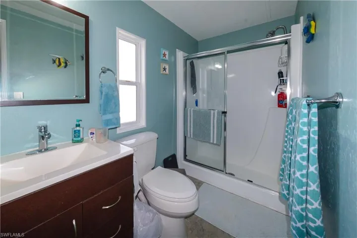 Full bathroom with a shower stall and vanity