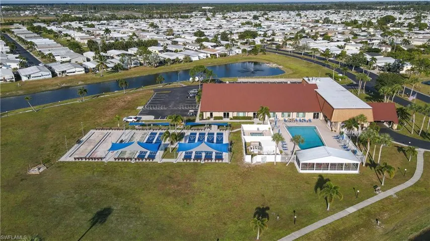 Aerial perspective of suburban area featuring a nearby body of water and a pool
