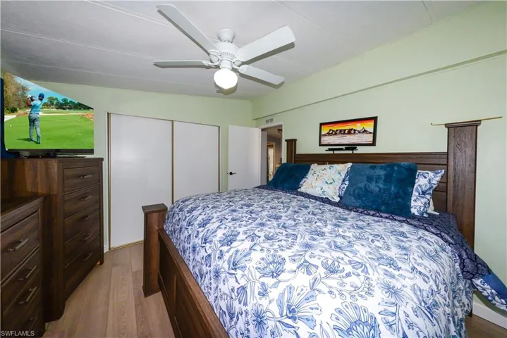 Bedroom featuring light wood-type flooring, ceiling fan, and a closet