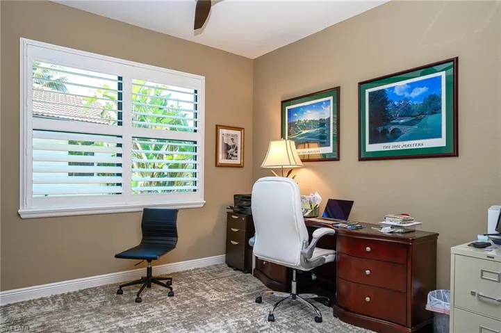 Home office featuring a ceiling fan and light colored carpet