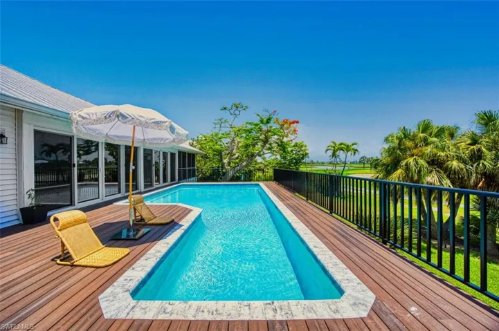 View of swimming pool with a deck