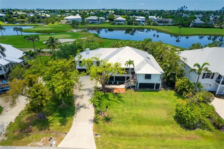 Aerial view of residential area featuring a lake and a golf course views