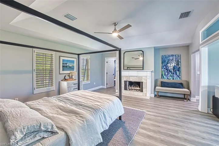 Primary bedroom with a fireplace for ambiance