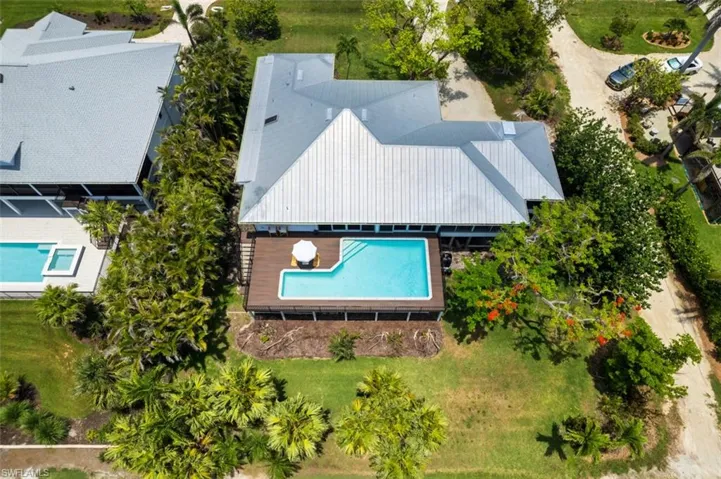 Aerial view of property and surrounding area with a pool area