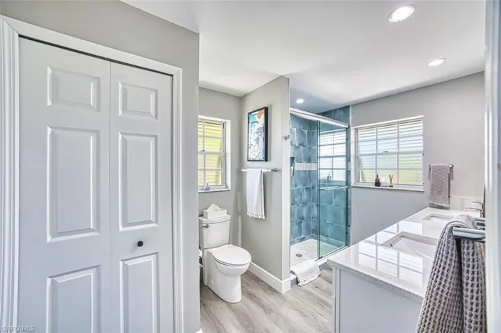 Updated Bathroom featuring double vanity, a shower stall,