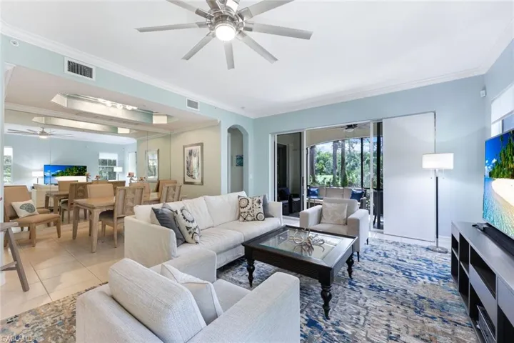 Living room with tile patterned flooring and crown molding