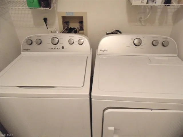 Washroom featuring washing machine and dryer