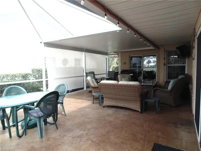 Sunroom with outdoor dining area, an outdoor living space, and a patio