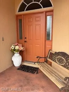 Property entrance featuring stucco siding