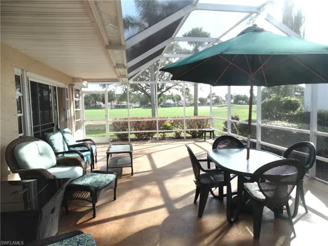 View of patio / terrace featuring a sunroom, glass enclosure, outdoor dining space, and outdoor lounge area