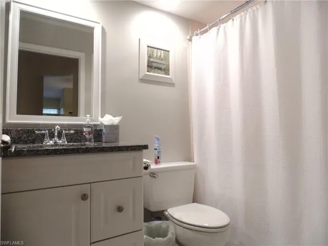 Guest bath with vanity and a shower with curtain