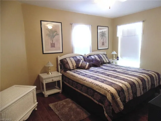 Bedroom with dark wood-style flooring