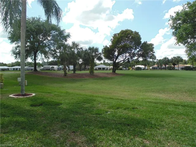 View of property's community with a yard