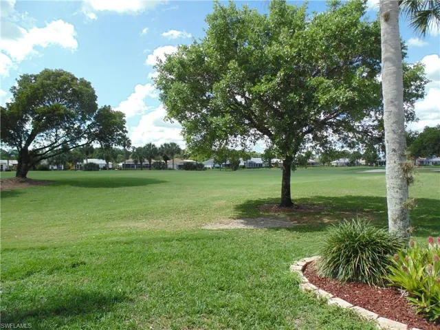 View of home's community with a yard