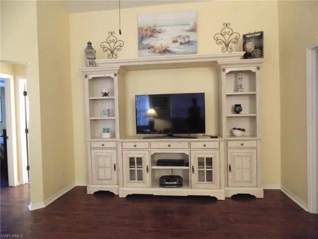 Living room with dark wood-type flooring