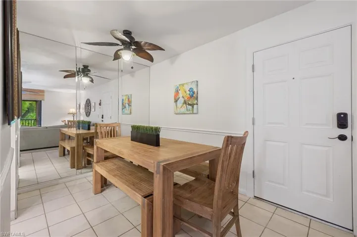 Dining room featuring light tile patterned flooring and ceiling fan