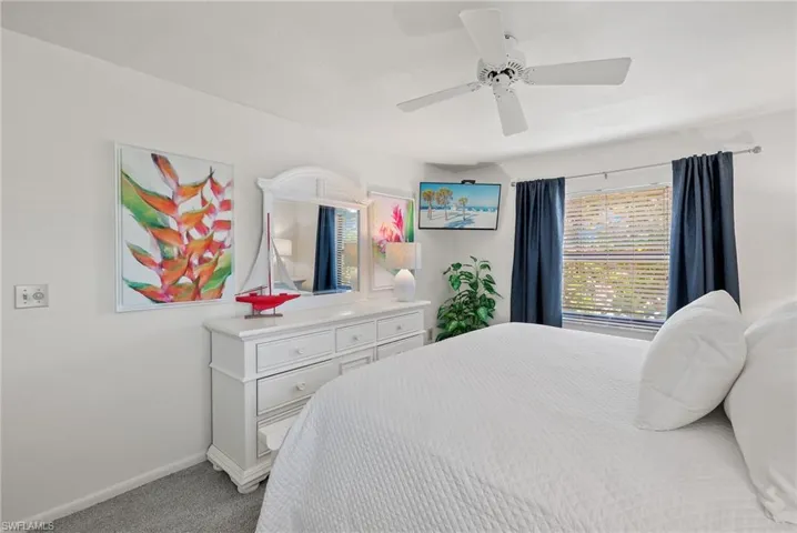 Bedroom featuring light colored carpet and ceiling fan