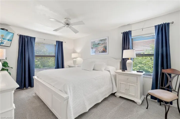 Bedroom featuring light carpet and a ceiling fan