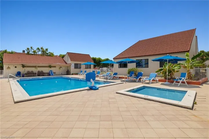 Community pool featuring a patio area and a hot tub
