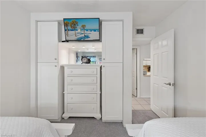 Carpeted bedroom with tile patterned floors