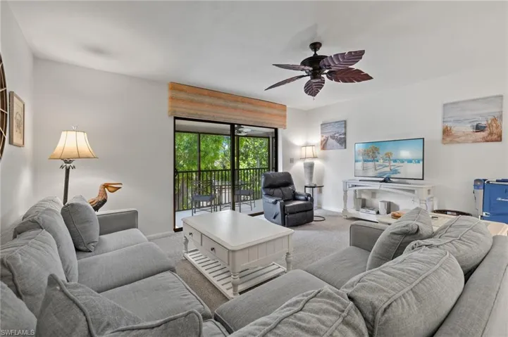 Living area featuring carpet floors and ceiling fan