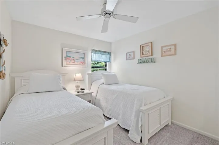 Bedroom featuring light colored carpet and a ceiling fan