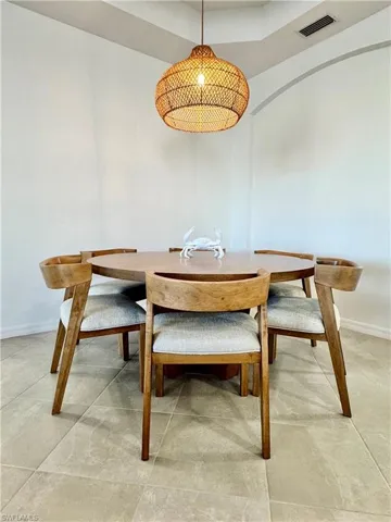 Dining area with baseboards and a raised ceiling