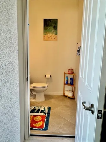 Outdoor Bathroom in lanai with vanity, a walk in shower, and light tile patterned floors