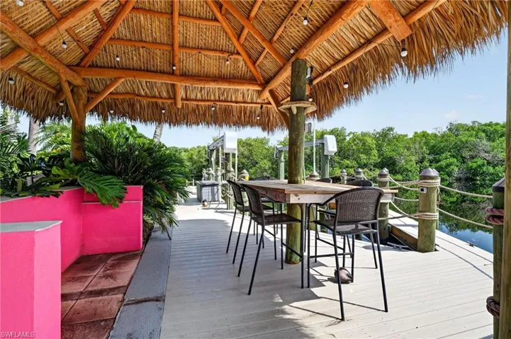 Tiki hut with dining table.